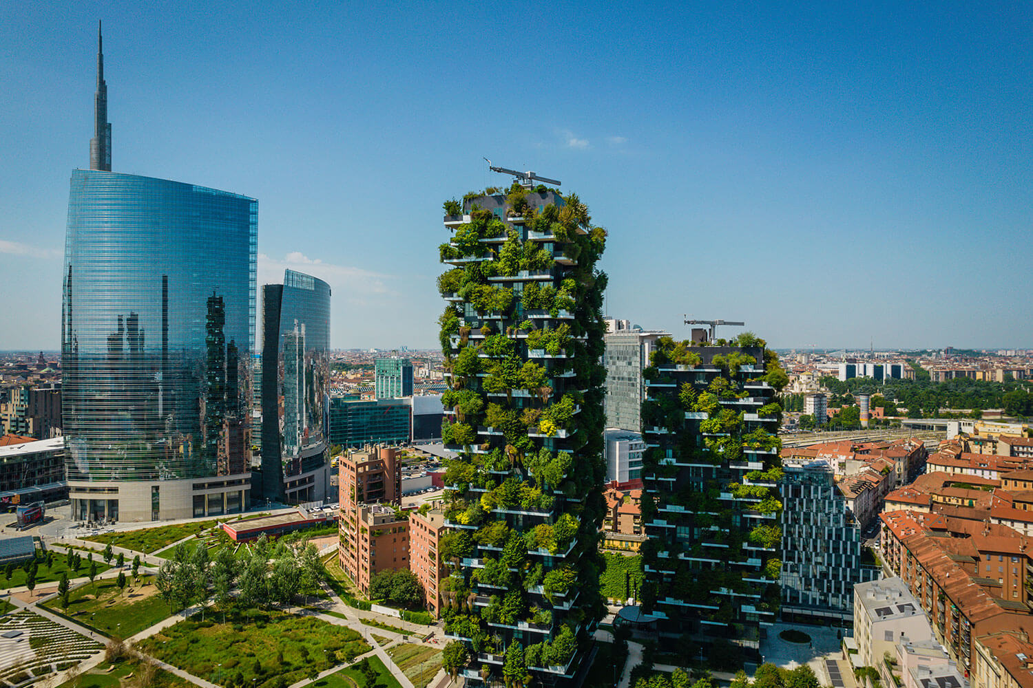 Aerial photo of Bosco Verticale, Vertical Forest, in Milan, showing residential buildings with many trees and other plants in balconies