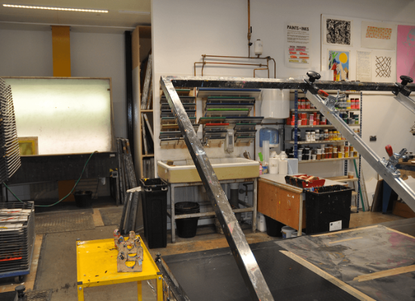 An image of the screenprinting workshop at Locksbrook Campus, including a screenprinting bed