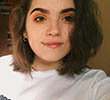 A younger Alice Fortt smiling in her room