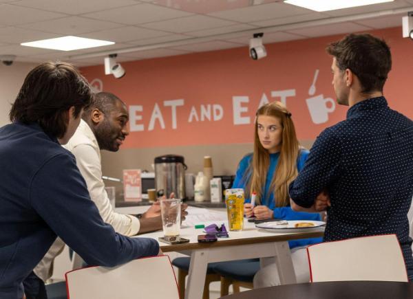 a group of people stood around a table
