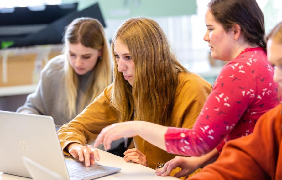 students looking at laptop