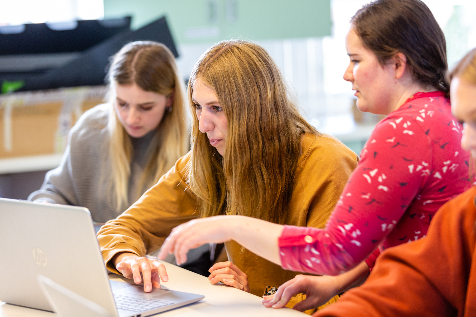 Students looking at a laptop screen