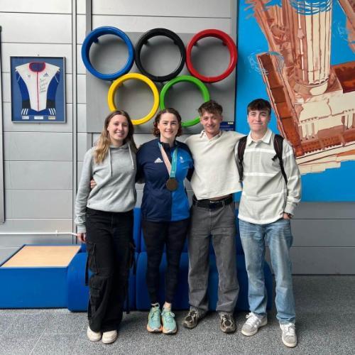 Group of young people stood in line with famous Olympian