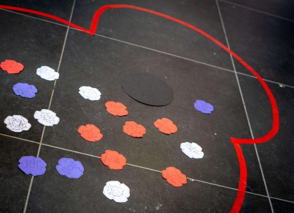 Messages written on paper poppies, creating poppy design on the floor