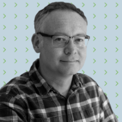 A man wearing glasses and a plaid shirt.