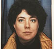 A younger Sue Rigby smiling and wearing a cool jacket