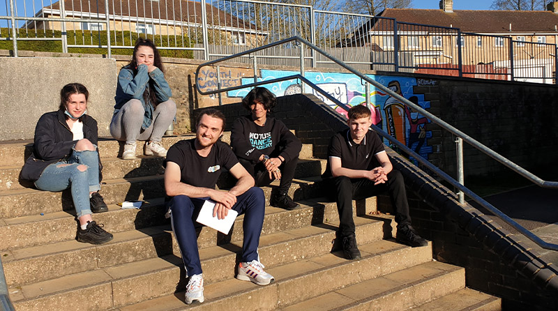 5 Youth Connect Volunteers sat on some steps