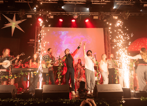 A group of performers celebrating on stage