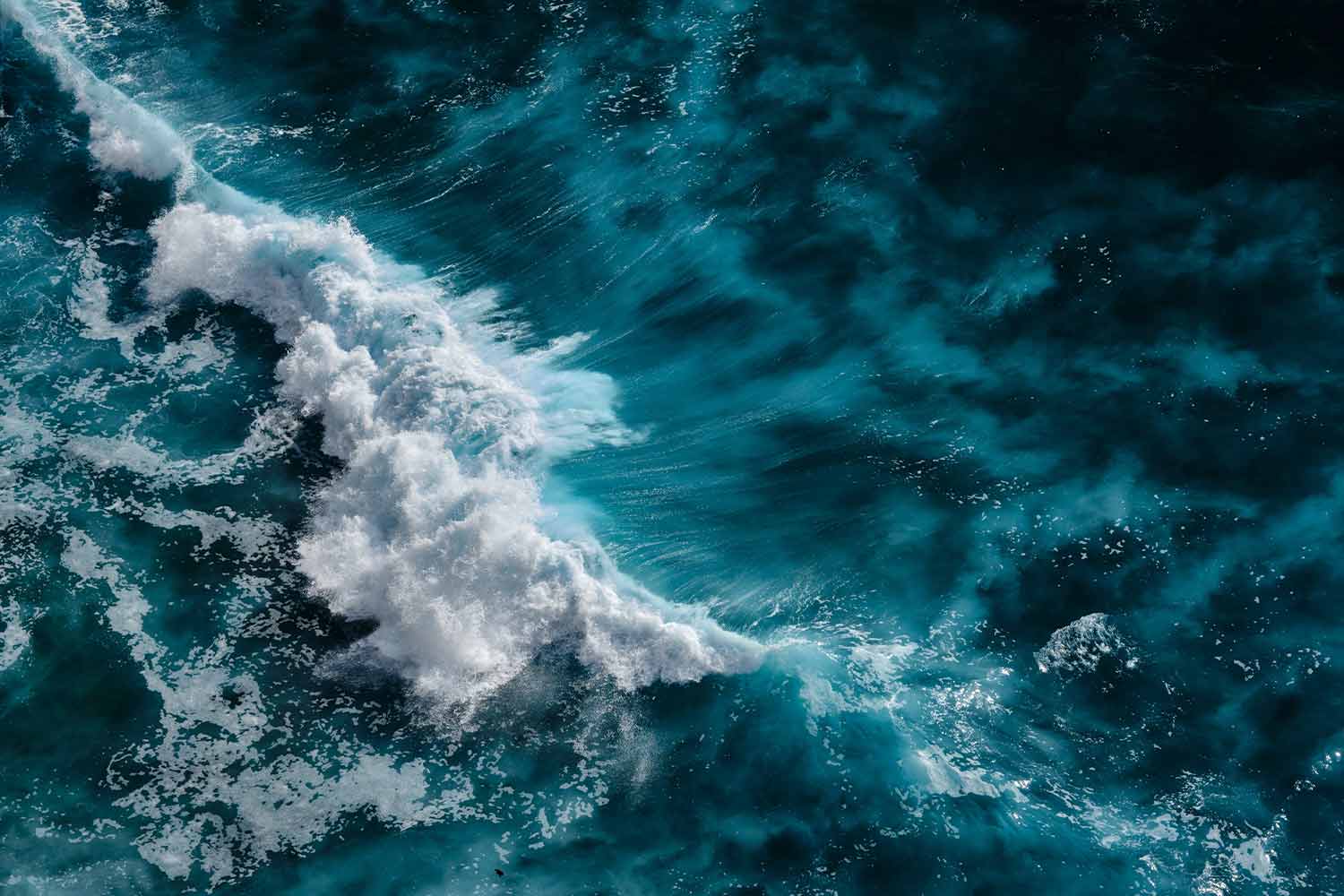 Overhead shot of froth on turquoise ocean