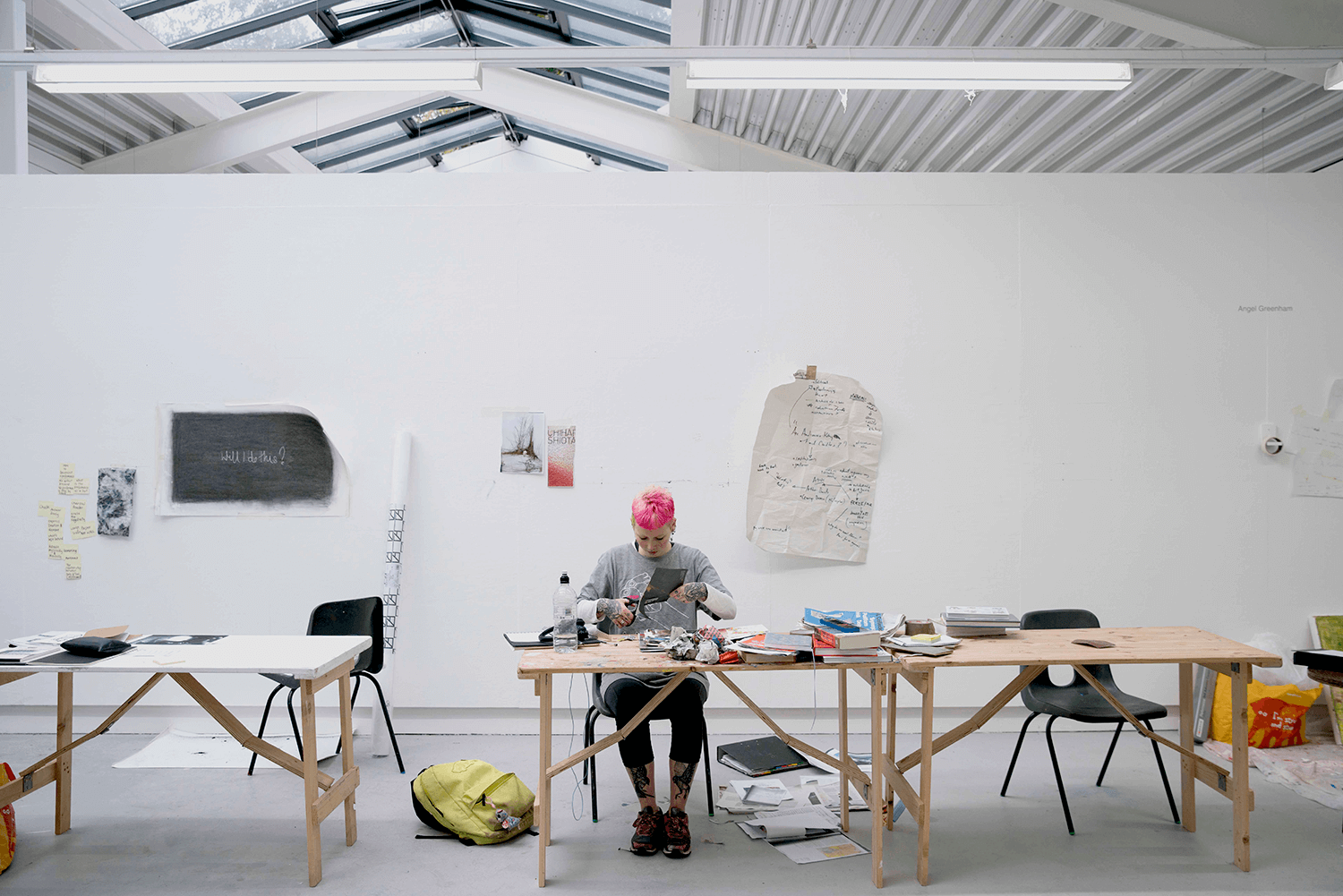 Student with pink hair working on art project