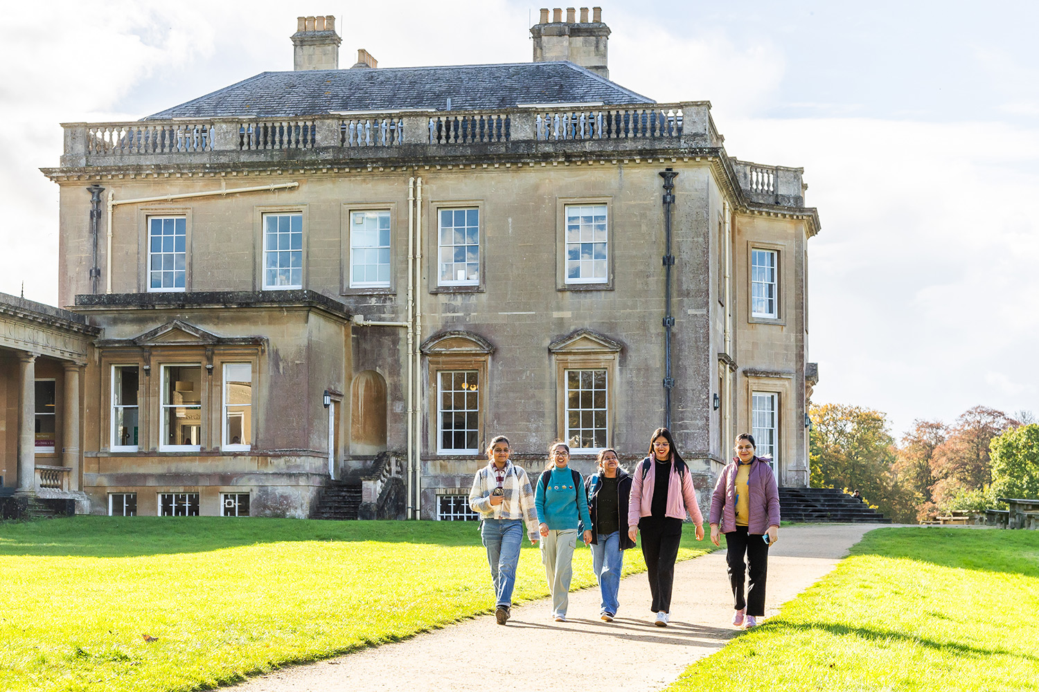 Students walking past main house