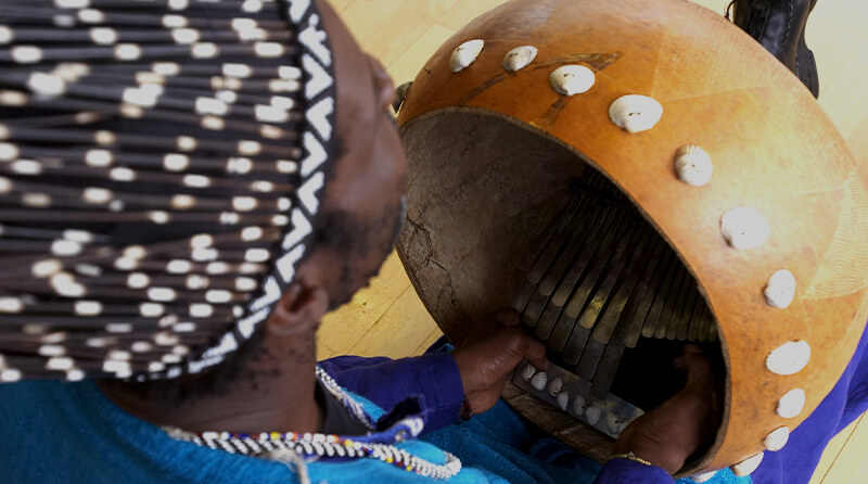 A person playing a mbira instrument