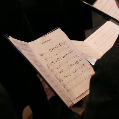 Music sheet being held by a choir singer