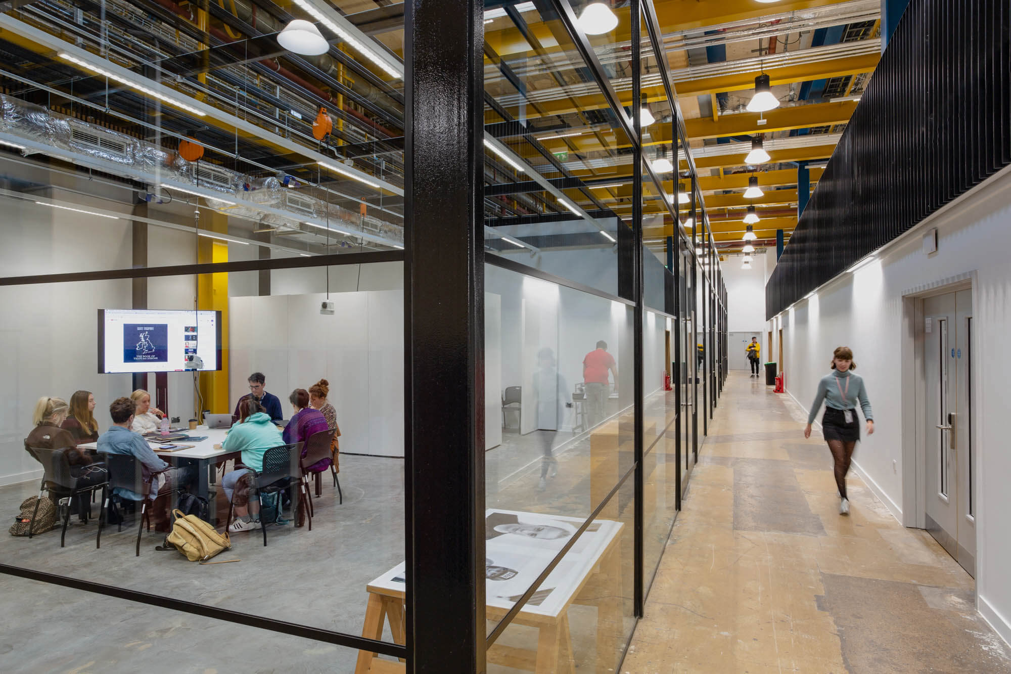 Internal view of Bath Spa University Locksbrook Campus showing a glass-windowed study and meeting room