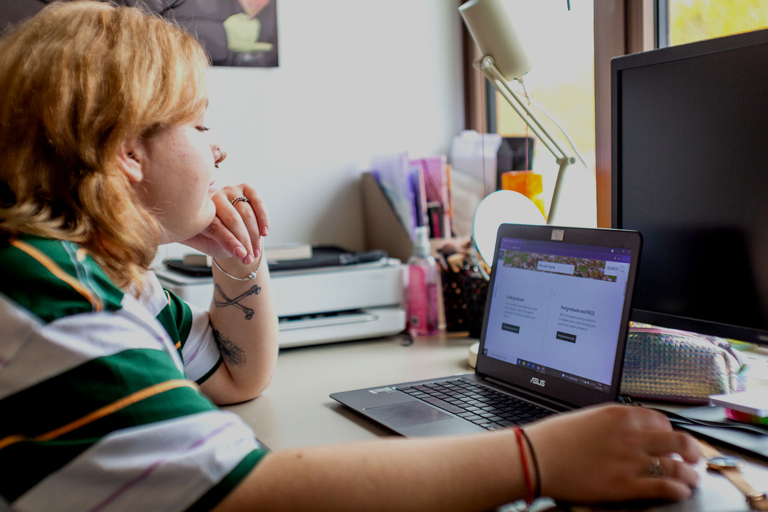Student using laptop in their room in student accommodation