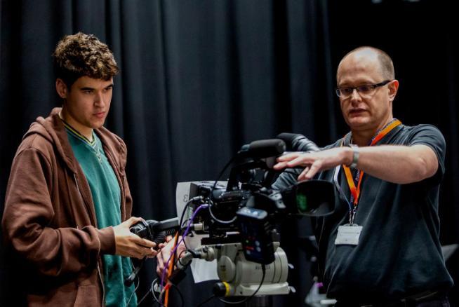 Student and a technician using a TV camera