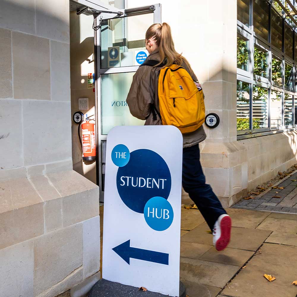 Image of student entering Twiverton with hub sign in foreground