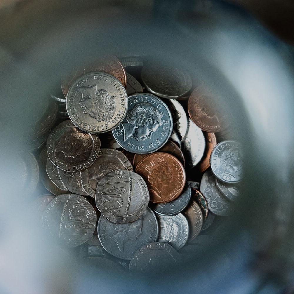Close up view of coins in a jar