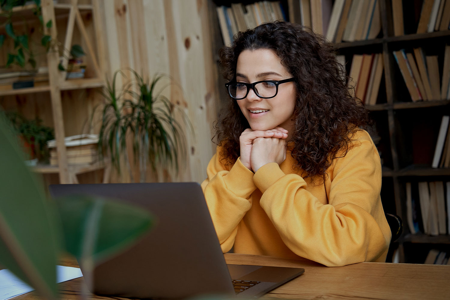 A young female student working at a laptop