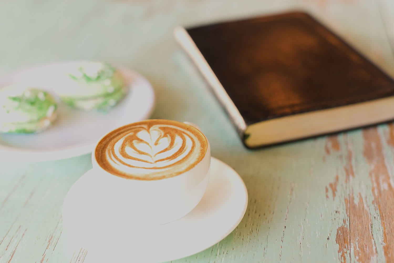 Cup of coffee next to a book