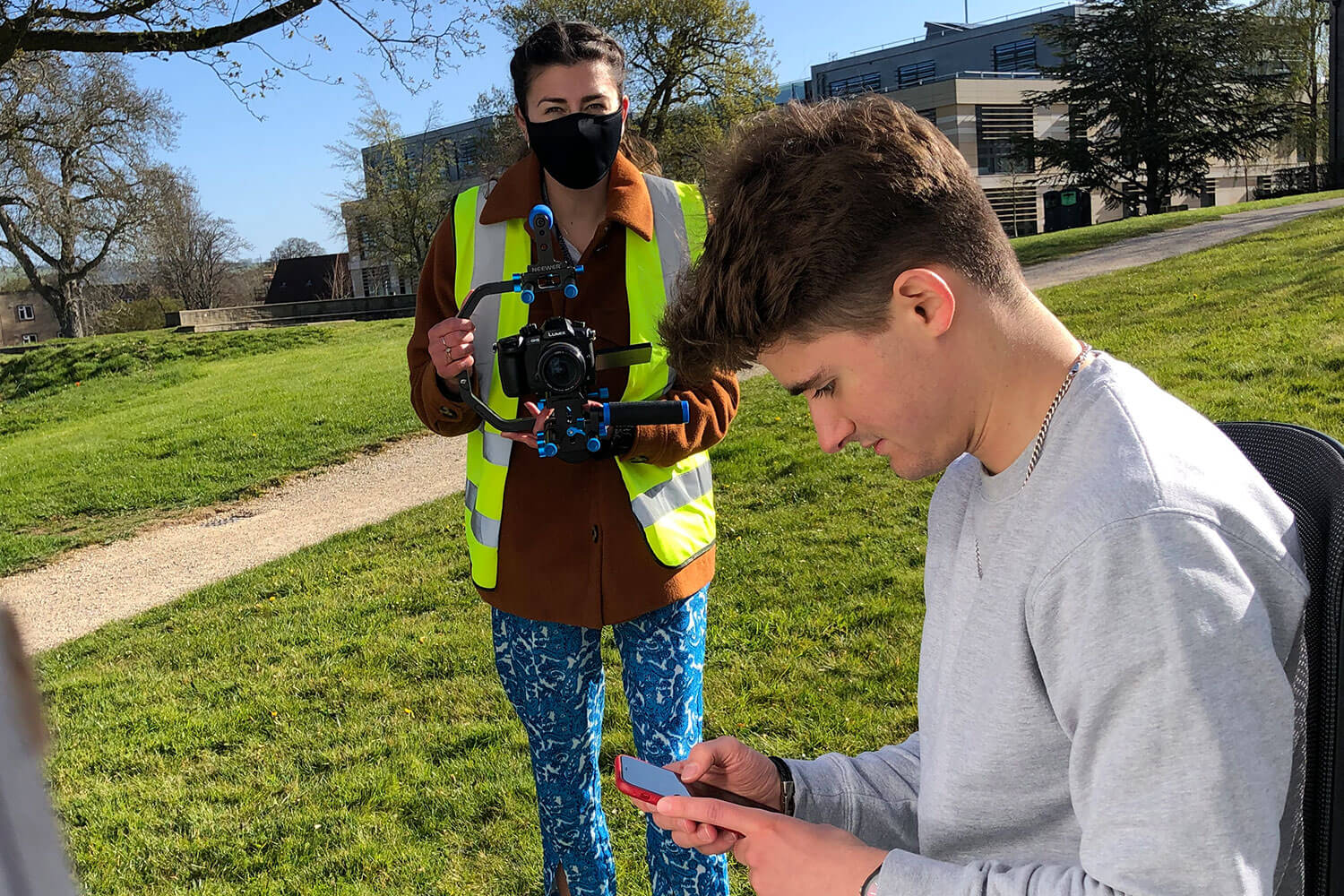 Filming a young man looking at his phone