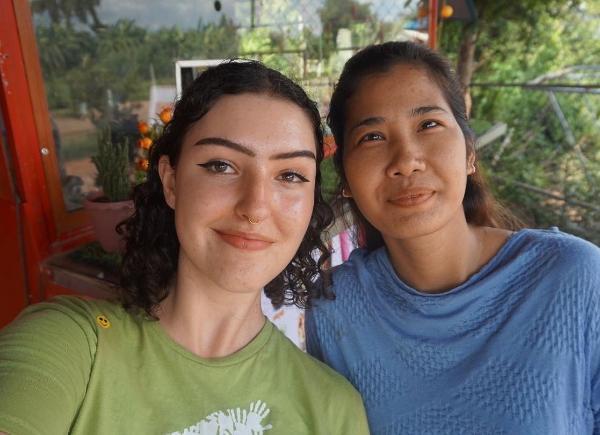 Student Ray Lewis (a female with dark curly hair) with a Cambodian woman