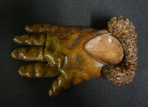 A wooden dish shaped like a glove