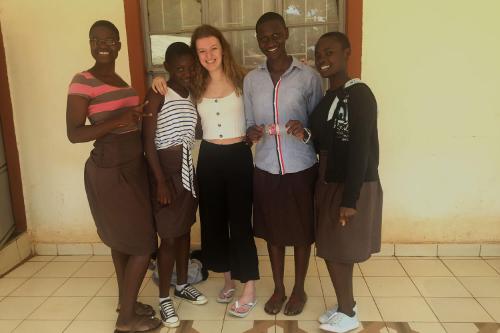 Holly with her arms around a group of smiling people