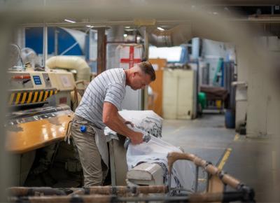 An image showing a worker checking a sheet of material