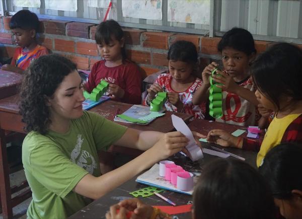 Ray Lewis helps some Cambodian school children with a craft activity