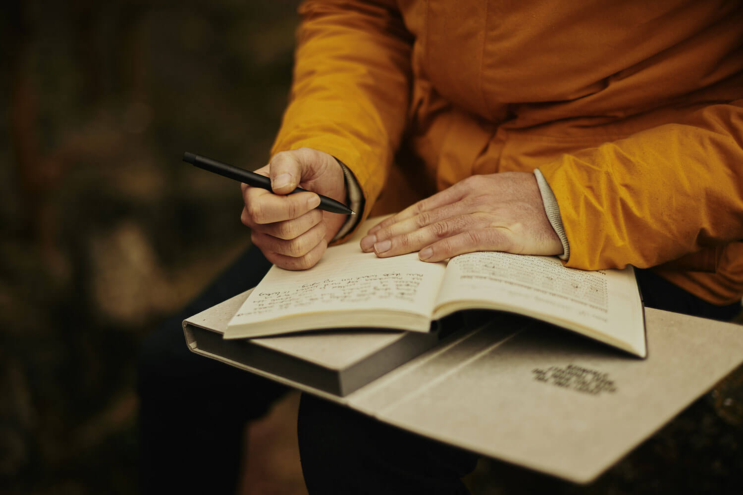 Writing in a journal, outside in nature