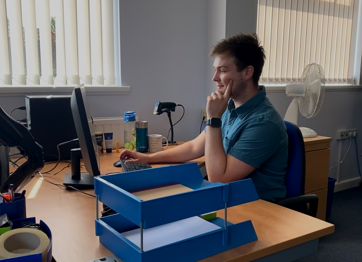 Ollie Wilkes sat at his desk, using his computer