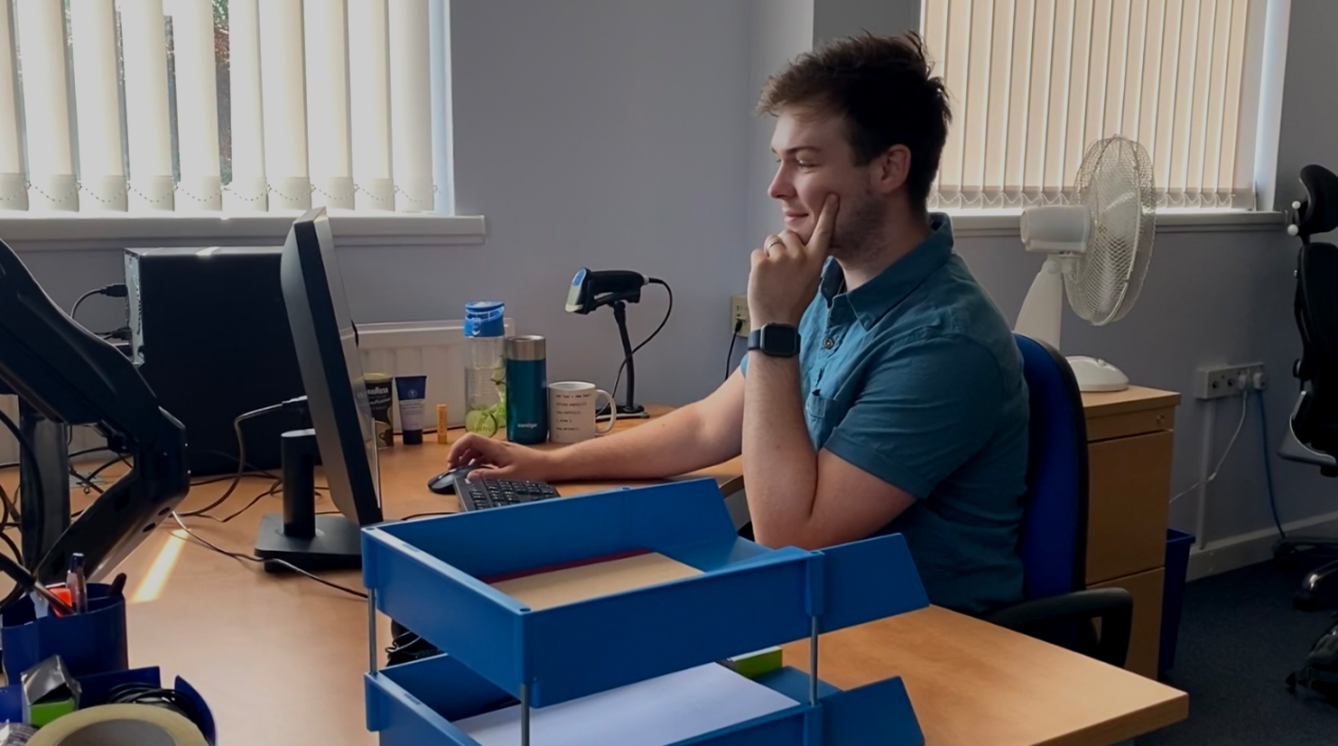 Ollie Wilkes sat at his desk, using his computer