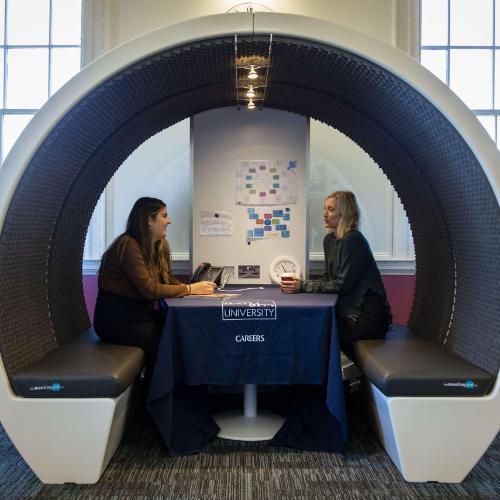 Two people having a discussion in a Careers booth
