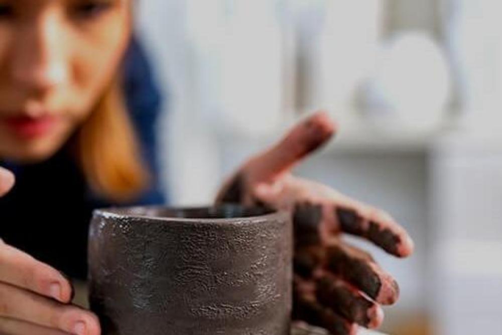 Woman sculpting pottery
