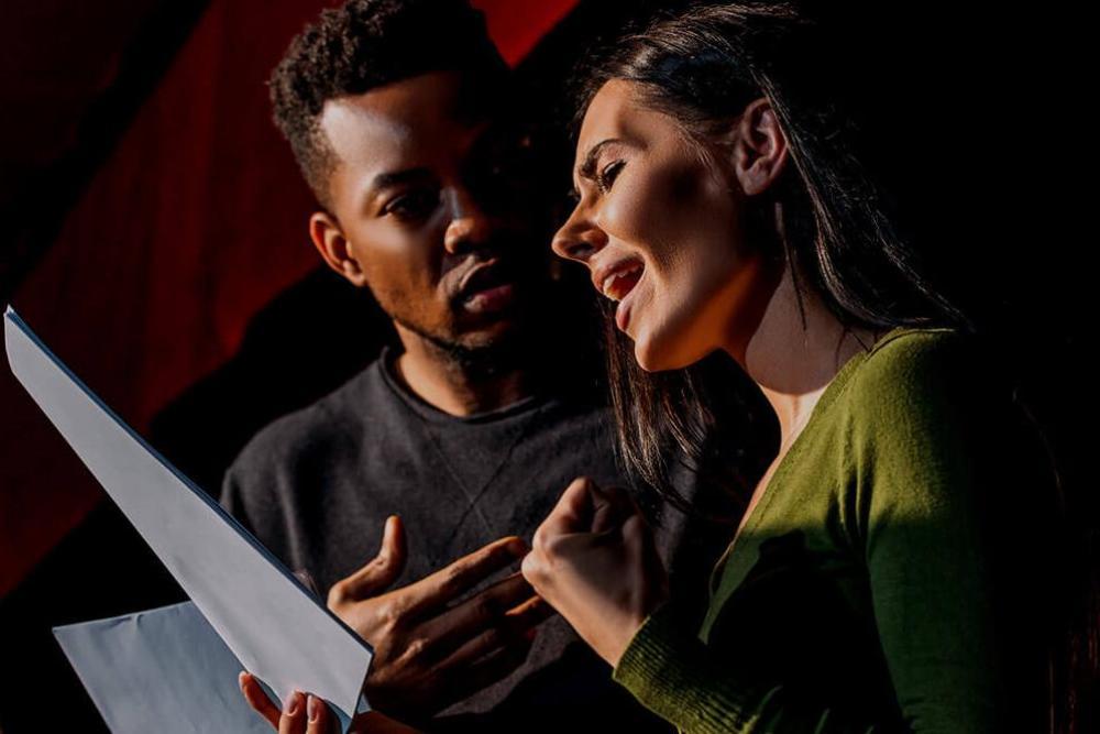 Acting students rehearsing their lines on stage