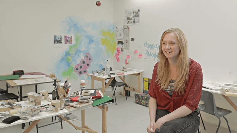 A woman being interviewed in an art studio