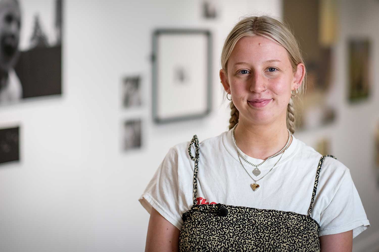 A person with long, blonde hair smiles at the camera
