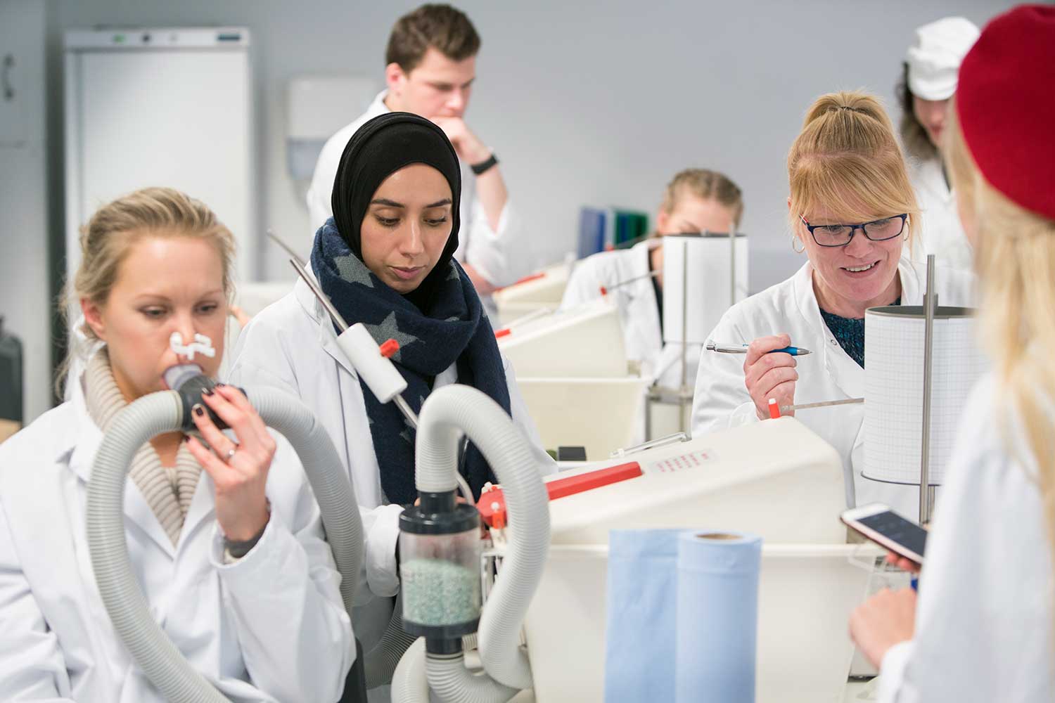Science students conduct an experiment in the science lab