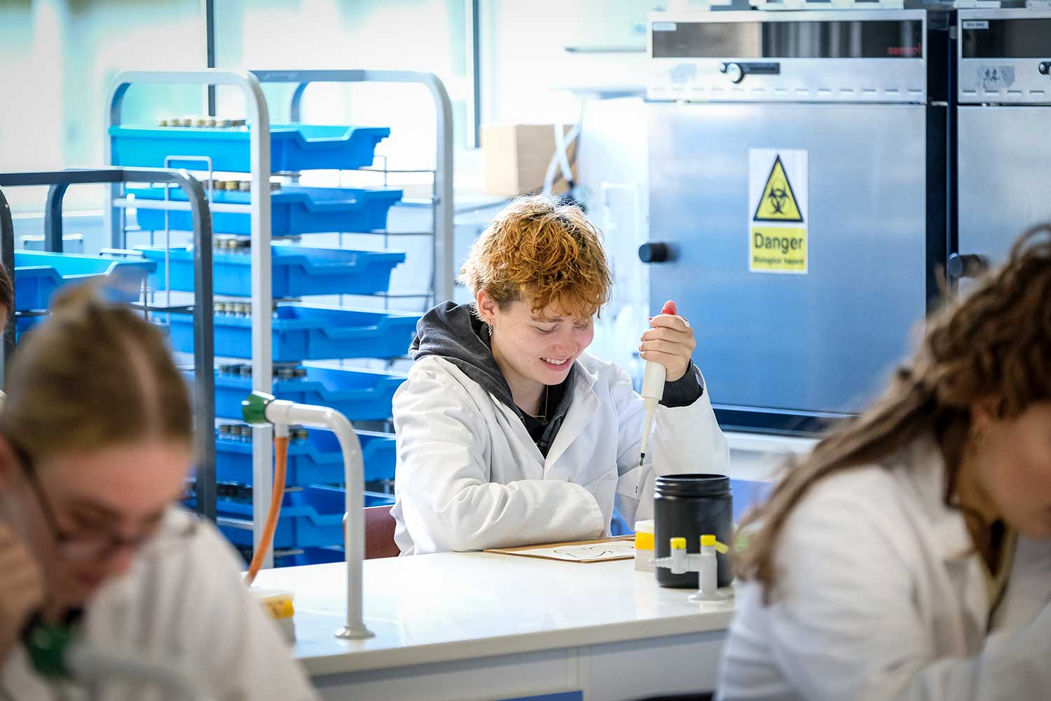 A student conducts an experiment in the science labs
