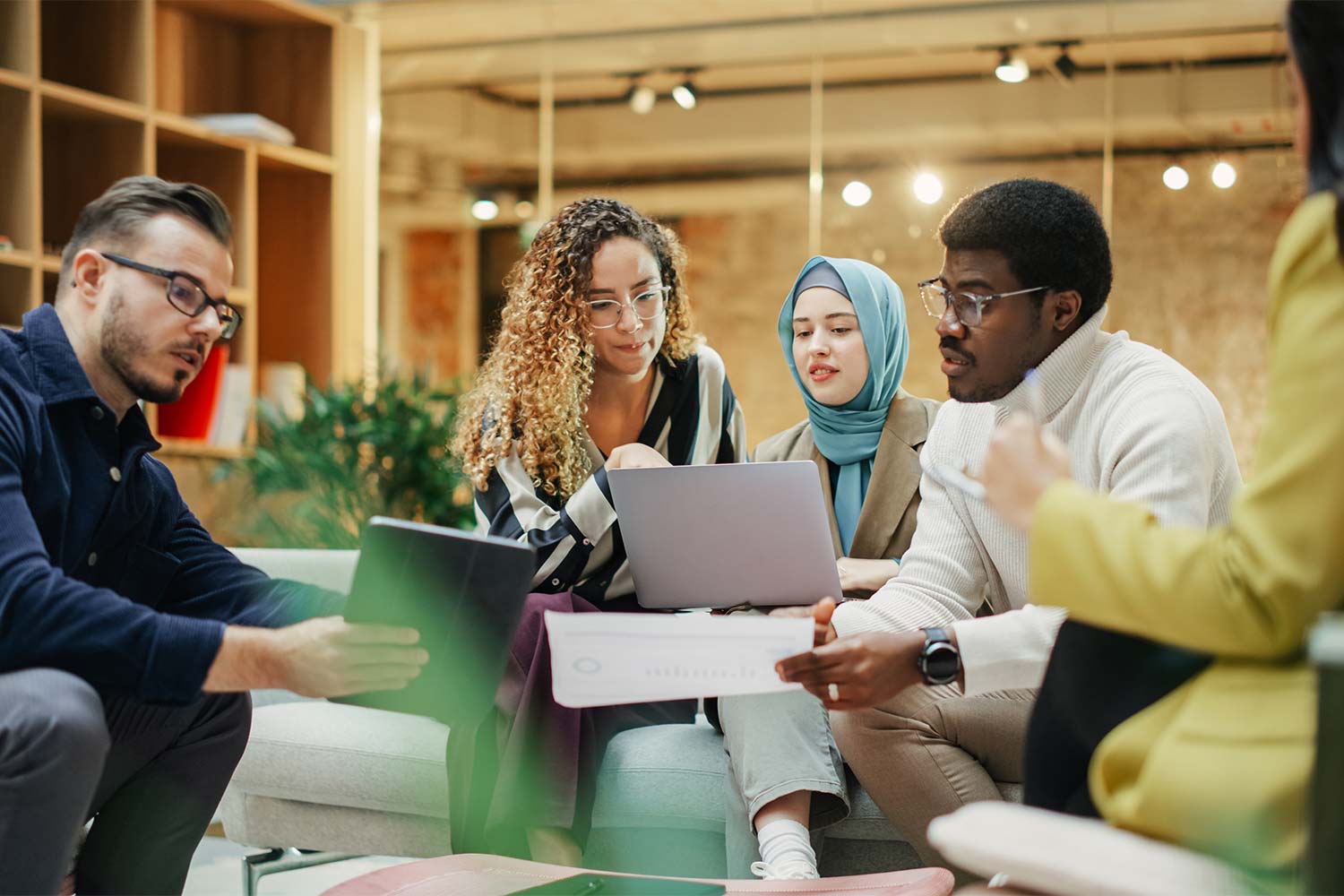 Photo of diverse group of people sitting in informal business meeting