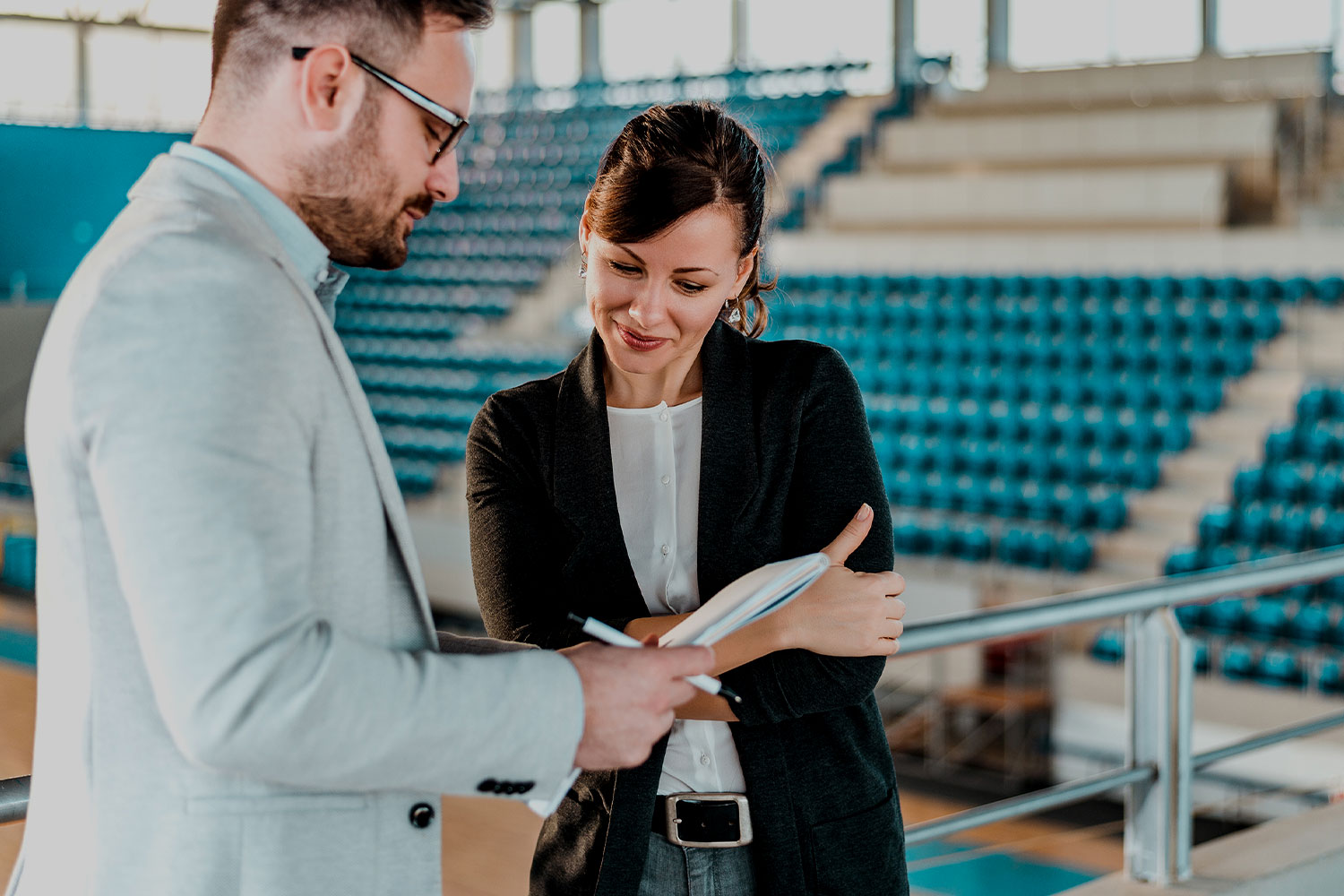 Woman and man in a leisure centre looking at a clipboard.