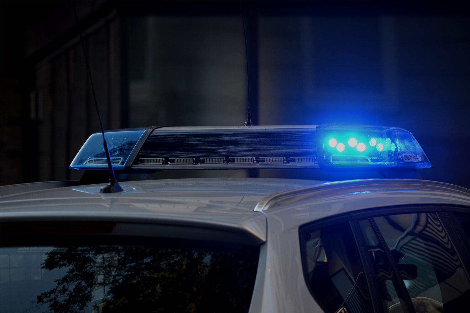 Top of a police car with sirens lit up.