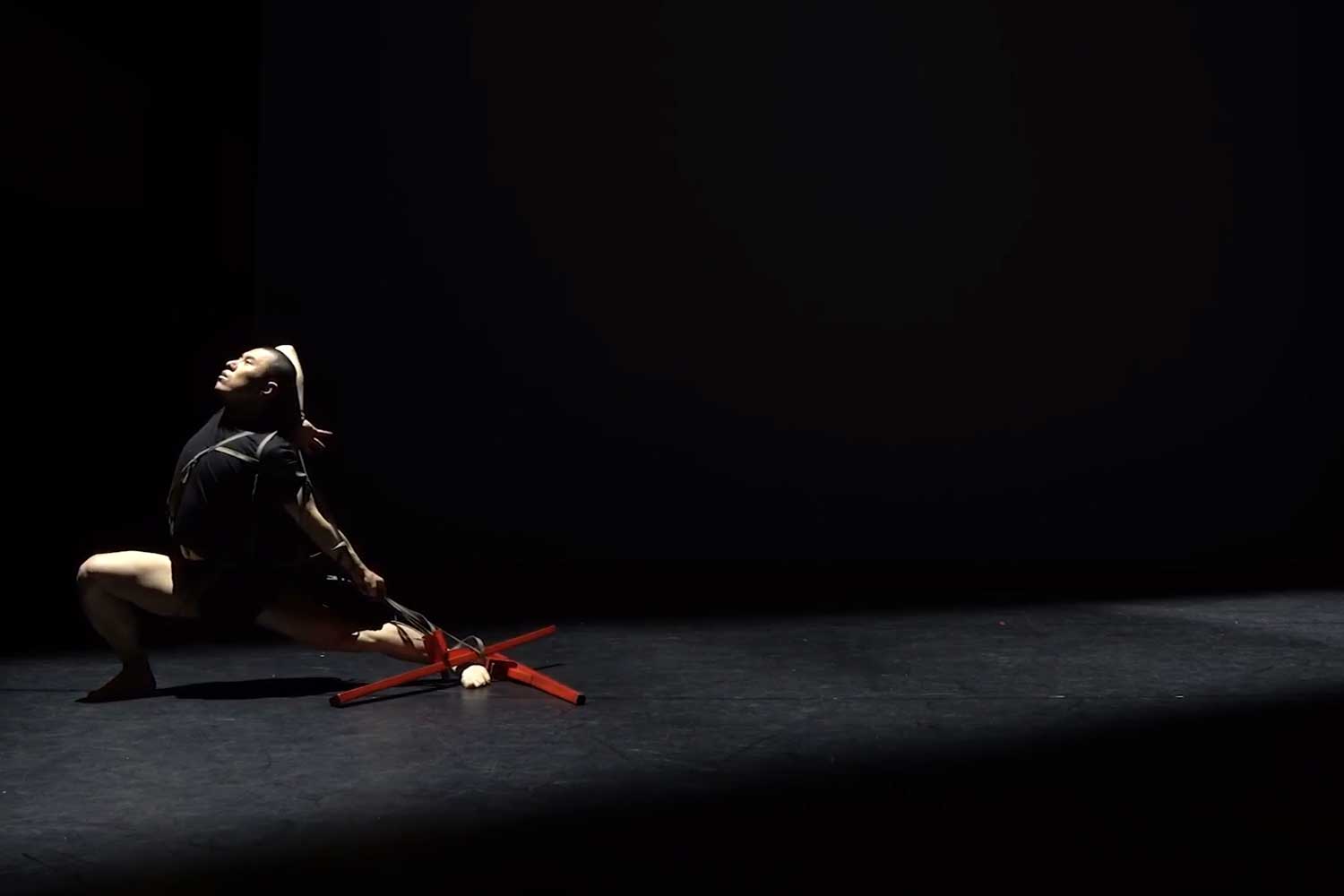 A dancer lunges and lifts one arm over their head