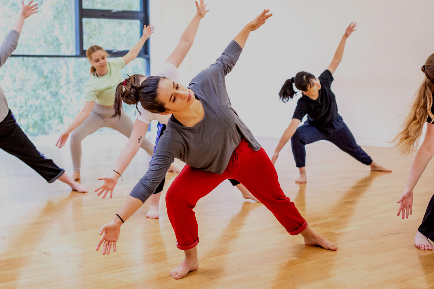 Dancers stretching in studio