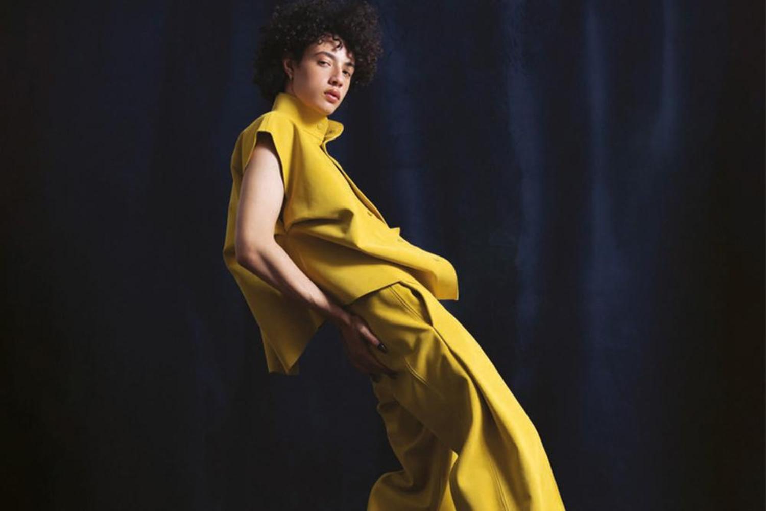 Person in yellow trouser suit on stage