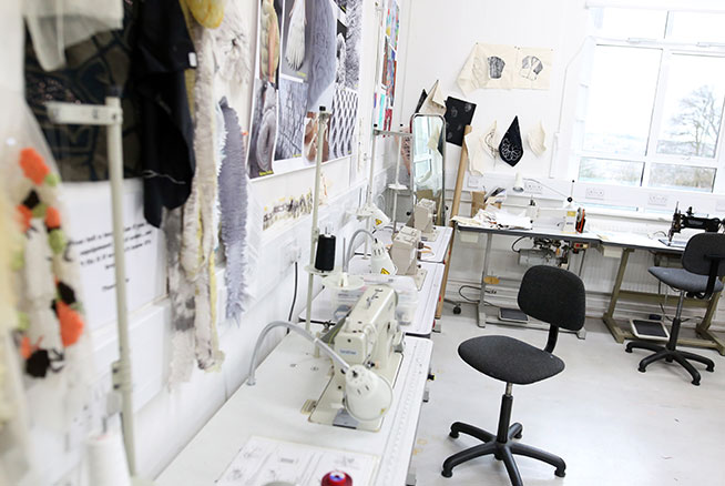 A textiles studio with table, chair and various works in progress