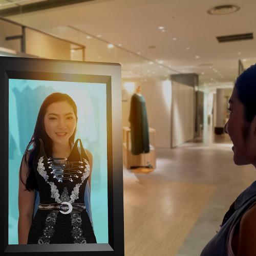 Shopper trying on clothes with an augmented reality smart display