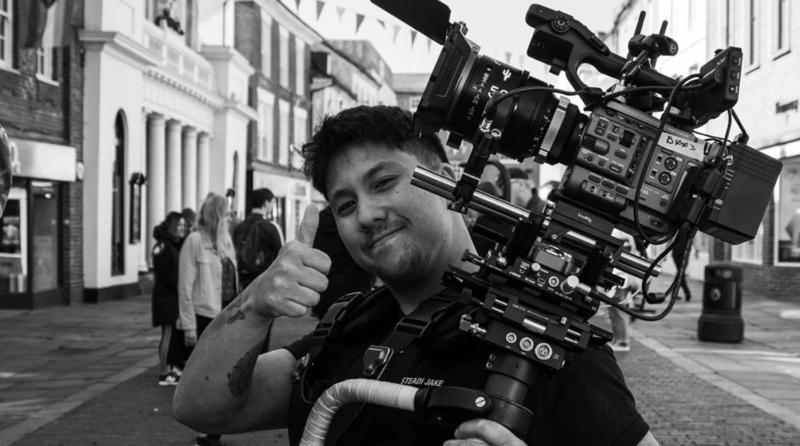 Photo of someone on set with a large camera