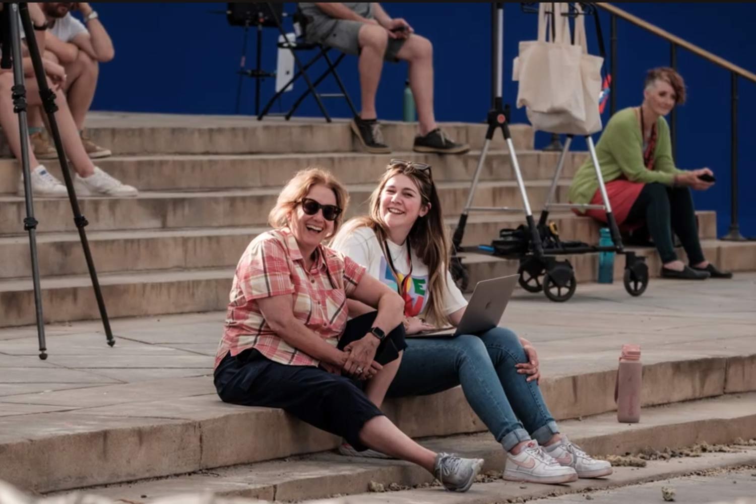 Image of two people sitting on location on film set